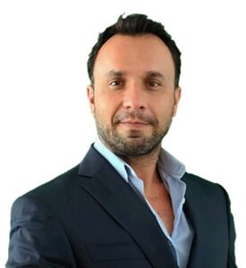 Professional man in a suit, presenting a confident demeanor, suitable for legal or business settings.