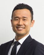 Lawyer smiling in professional attire against a neutral background.