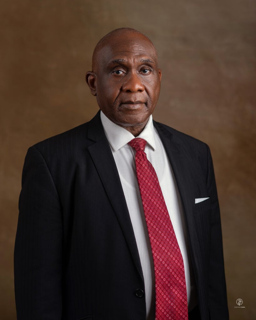 Lawyer in formal attire with a red tie, posing against a neutral background.