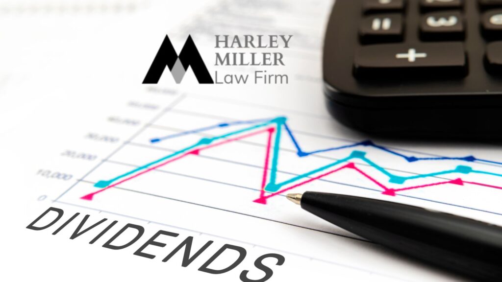 Graph and financial chart with the text "DIVIDENDS," a pen and calculator, reflecting legal financial analysis.