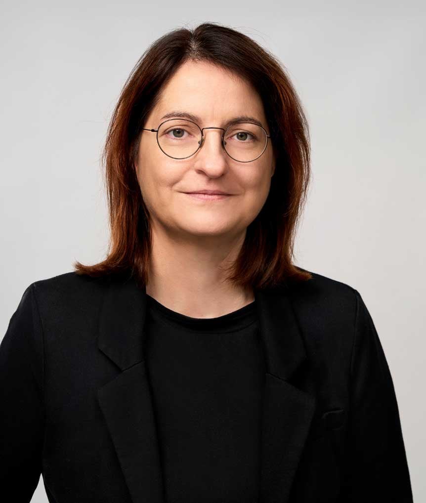 Professional attorney wearing glasses and a black blazer, posed against a neutral background.