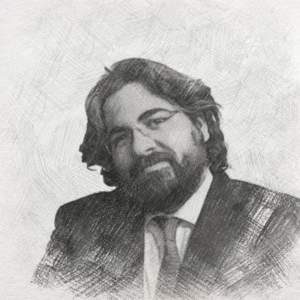 Bearded attorney in a suit smiling, with a neutral background, suggesting a professional legal atmosphere.