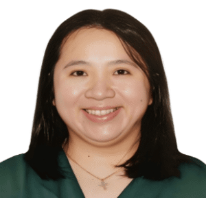 Smiling woman with medium-length black hair, wearing a green top, against a white background.