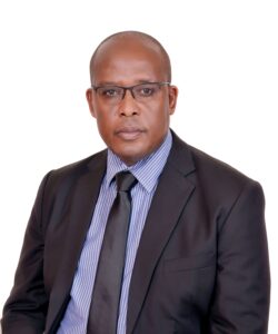 Legal professional in a suit with glasses, posing for a formal portrait against a plain background.
