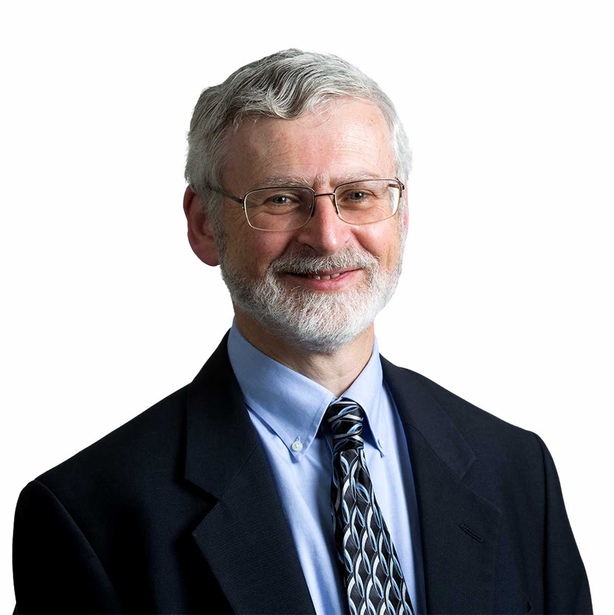 Lawyer smiling in professional attire, wearing glasses and a tie, against a plain background.