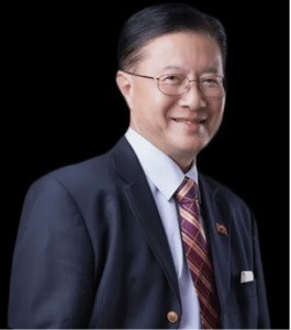 Lawyer smiling in a suit, standing against a plain background.