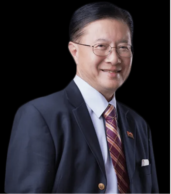Lawyer smiling in a suit, standing against a plain background.