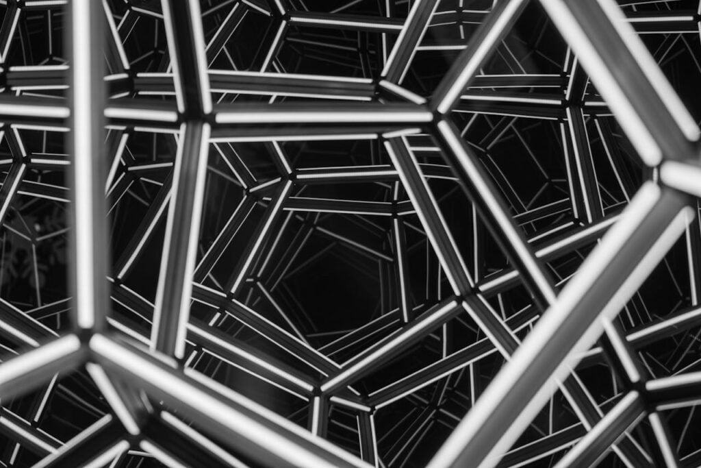 Abstract geometric structure composed of interconnected lines, creating a complex, symmetrical pattern.