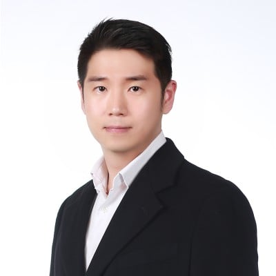 Professional attorney in a suit posing for a formal portrait with a neutral background.