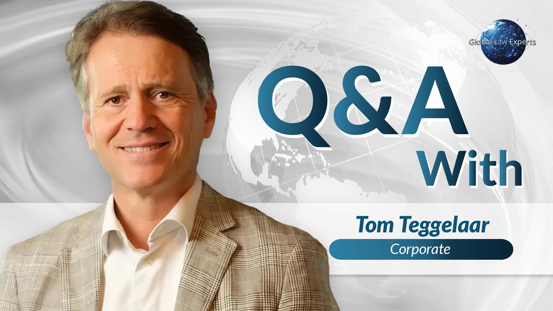 Corporate lawyer smiling in front of a world map background during a Q&A session.