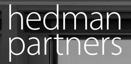 Law firm name "Hedman Partners" prominently displayed on a modern office wall.
