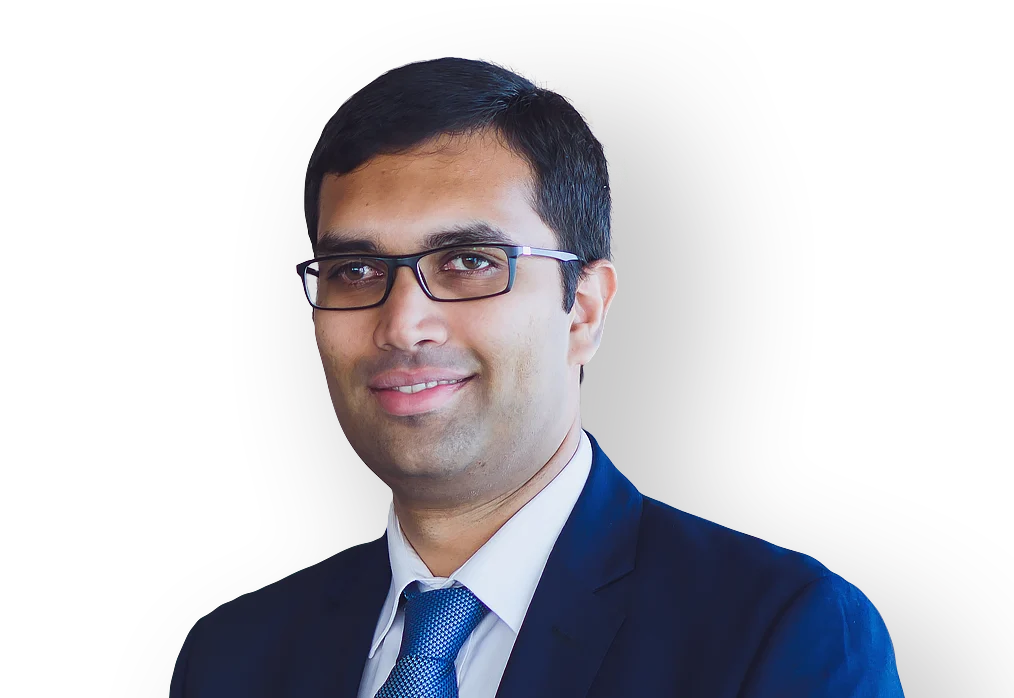Attorney smiling in professional attire, indicative of a legal expert in a formal setting.