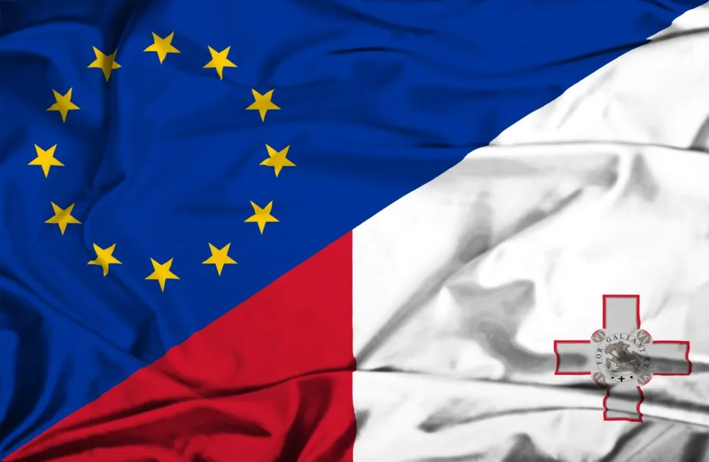 European Union and Malta flags displayed side by side, symbolizing legal and political connections.