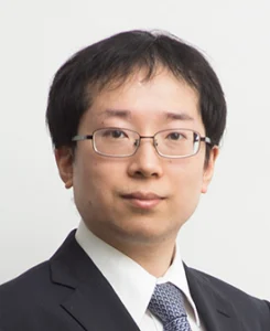 Lawyer in professional attire, looking directly at the camera against a plain background.