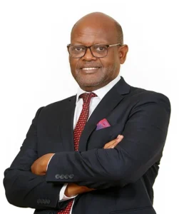 Attorney posing confidently with arms crossed, wearing professional attire against a neutral background.