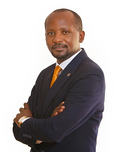 Lawyer posing confidently with arms crossed, wearing a suit and tie against a plain background.