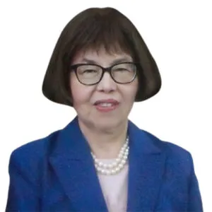 Attorney with glasses wearing a blue blazer, seated and smiling against a plain background.
