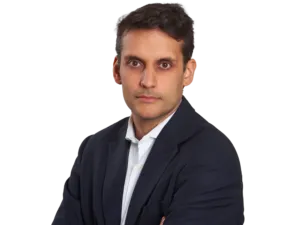 Lawyer in a suit with arms crossed, appearing confident and professional.